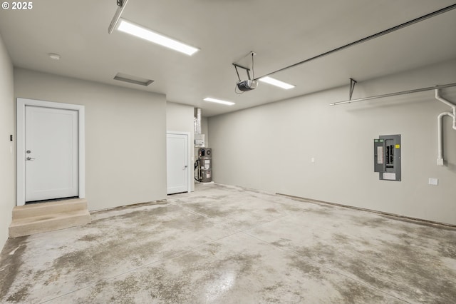 garage with a garage door opener and electric panel