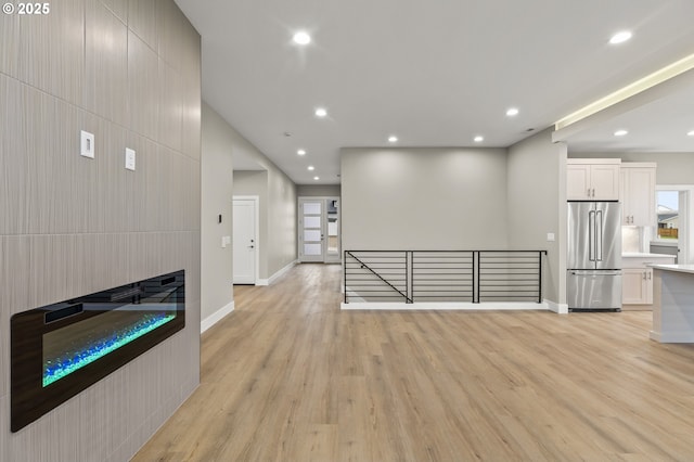 unfurnished living room with light hardwood / wood-style floors