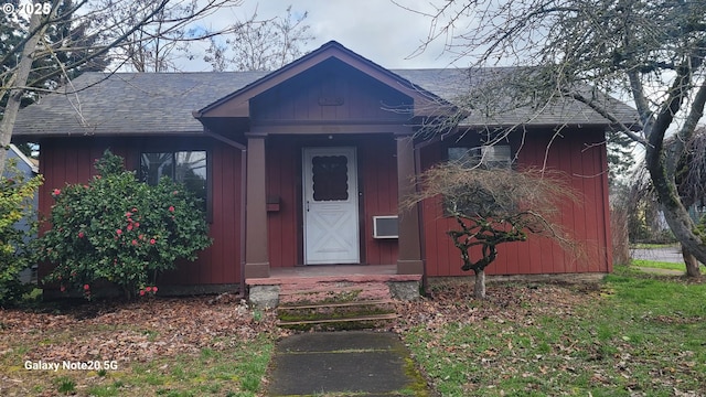 view of front of home with board and batten siding and a shingled roof