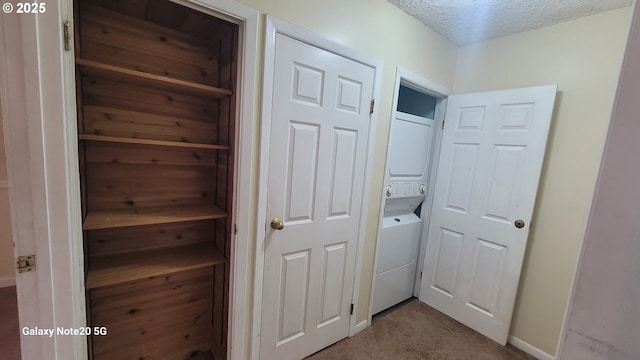 laundry room with stacked washer / dryer, a textured ceiling, laundry area, and carpet