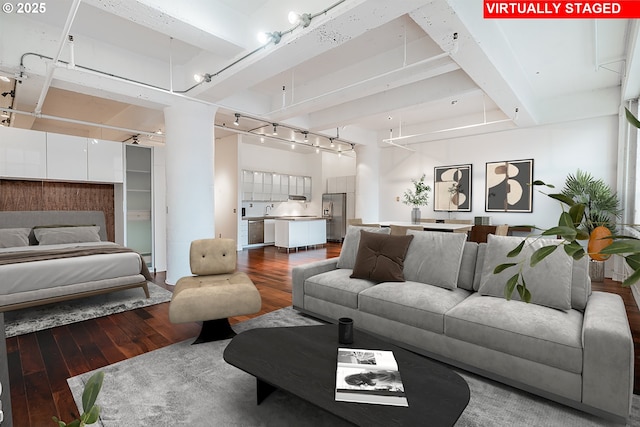 living area featuring beam ceiling, wood finished floors, and track lighting