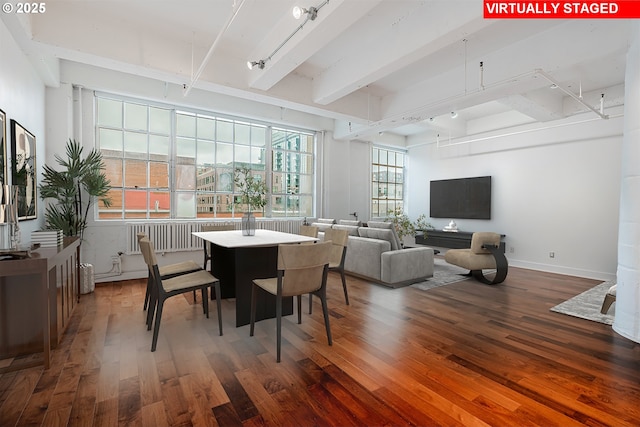 dining space featuring beamed ceiling, wood finished floors, and baseboards