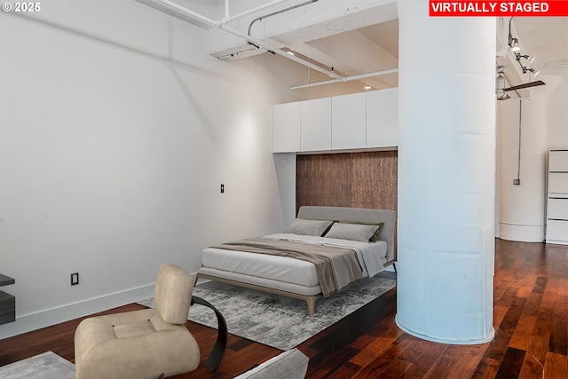 bedroom featuring dark wood finished floors and baseboards