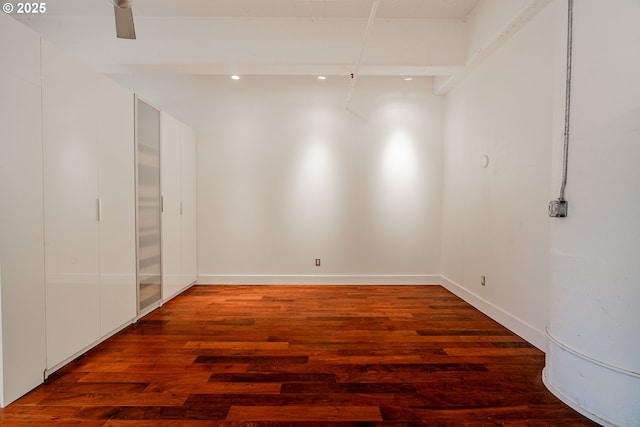 empty room with baseboards and wood finished floors