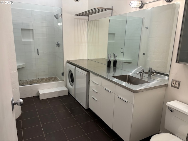 bathroom with vanity, washer / clothes dryer, a stall shower, tile patterned floors, and toilet