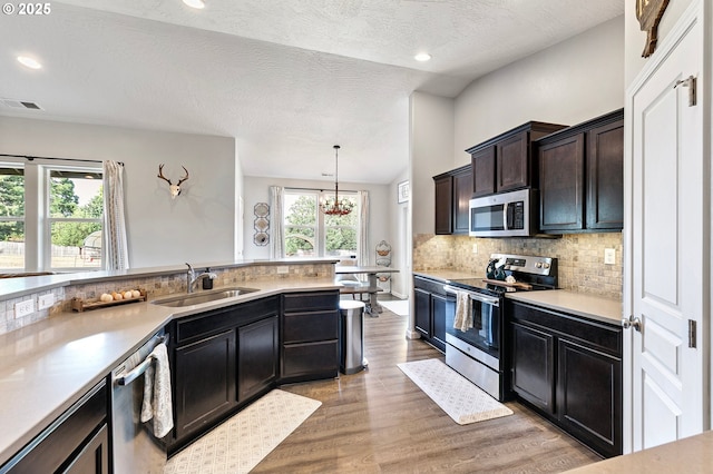 27 Anderson St, Yoncalla, OR 97499 - kitchen with stainless steel appliances, backsplash, light wood finished floors, light countertops, and lofted ceiling