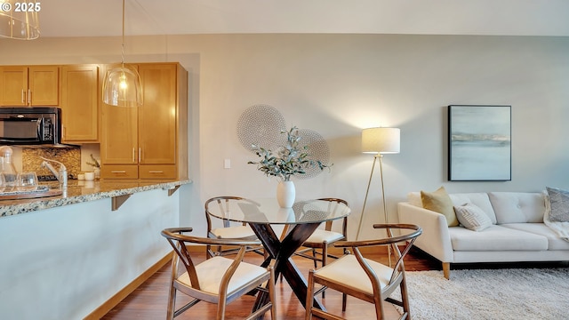 dining area with wood-type flooring