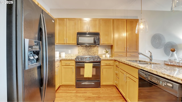 kitchen featuring sink, light hardwood / wood-style flooring, light brown cabinetry, and black appliances