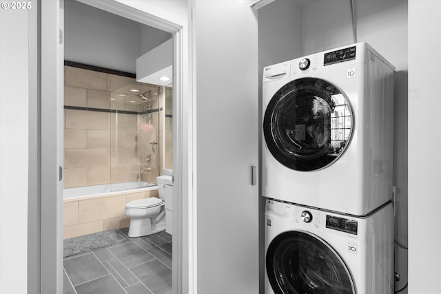 laundry area featuring stacked washer / dryer