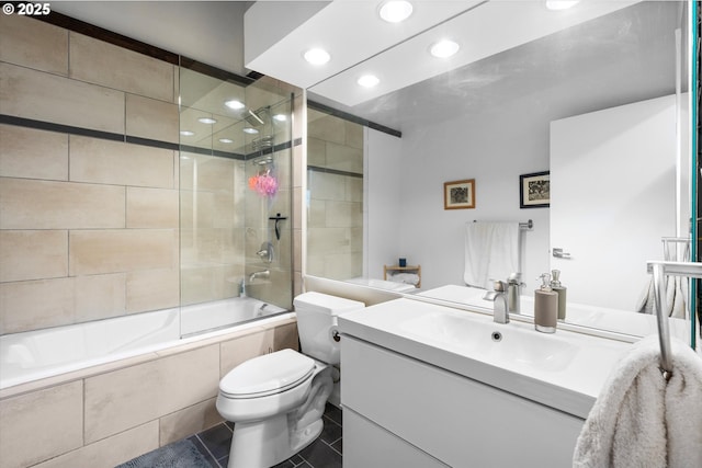 full bathroom with tile patterned flooring, vanity, combined bath / shower with glass door, and toilet