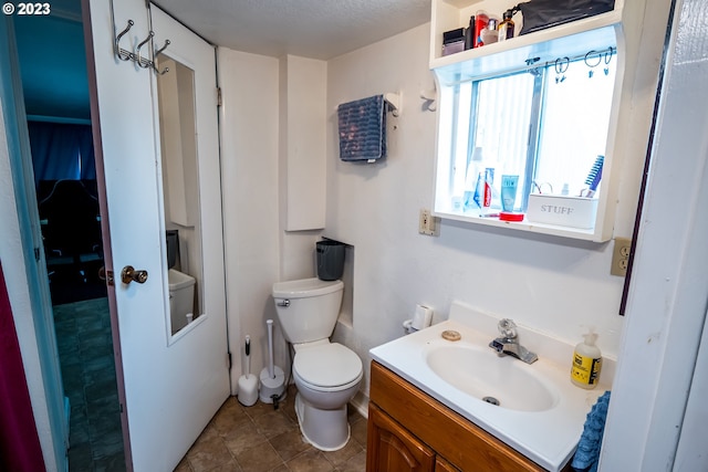 half bathroom with vanity and toilet