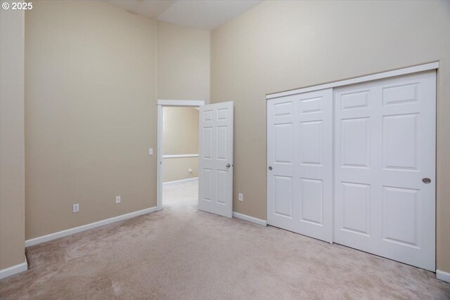 249 NW Mandi St, Hillsboro, OR 97124 - unfurnished bedroom featuring carpet, baseboards, a closet, and a high ceiling