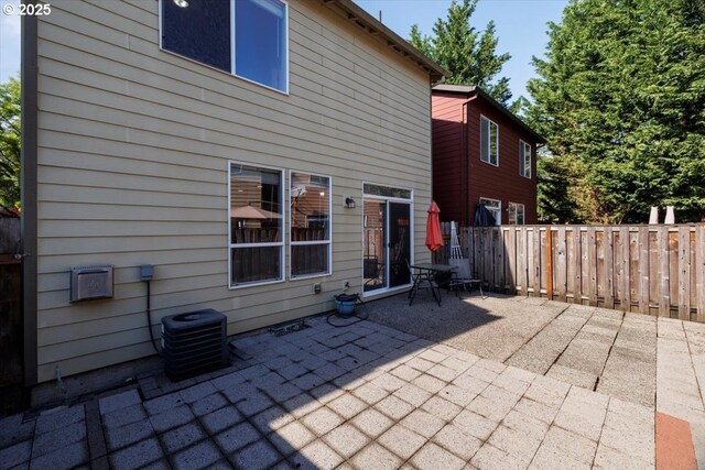 249 NW Mandi St, Hillsboro, OR 97124 - back of property featuring a patio, fence, and central AC