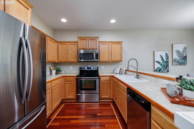 249 NW Mandi St, Hillsboro, OR 97124 - kitchen with appliances with stainless steel finishes, a sink, light brown cabinetry, dark wood-style flooring, and recessed lighting