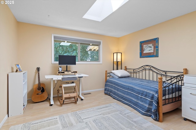2320 SW Canby Ct, Portland, OR 97219 - bedroom featuring light wood-style floors, a skylight, and an office area