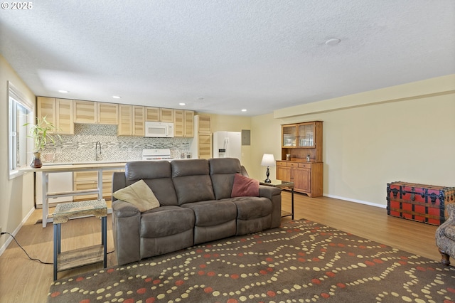 2320 SW Canby Ct, Portland, OR 97219 - living area featuring wood finished floors, a textured ceiling, and recessed lighting