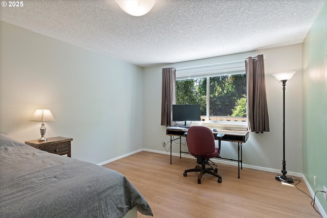 2320 SW Canby Ct, Portland, OR 97219 - bedroom featuring light wood-style floors, a textured ceiling, and a desk