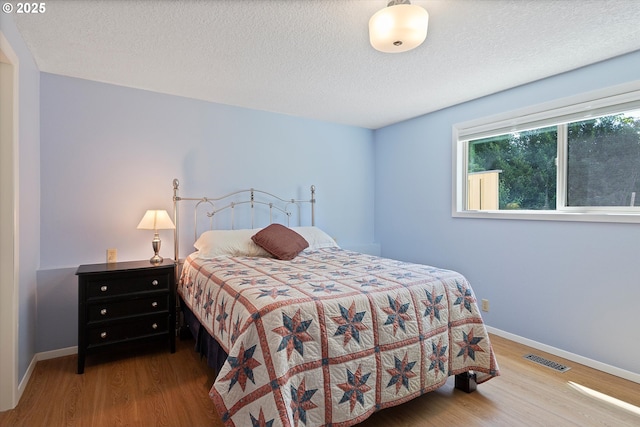 2320 SW Canby Ct, Portland, OR 97219 - bedroom with wood finished floors and a textured ceiling