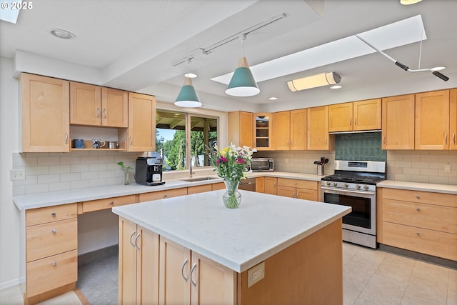 2320 SW Canby Ct, Portland, OR 97219 - kitchen with stainless steel gas stove, light brown cabinets, decorative backsplash, a kitchen island, and recessed lighting