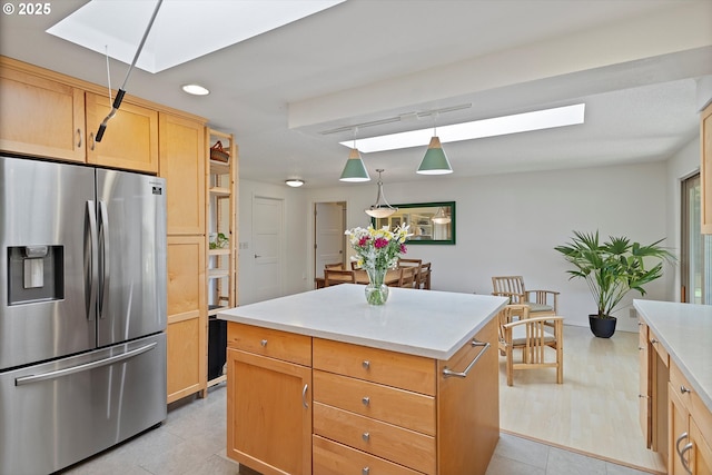 2320 SW Canby Ct, Portland, OR 97219 - kitchen featuring stainless steel fridge with ice dispenser, a skylight, light countertops, recessed lighting, and a center island