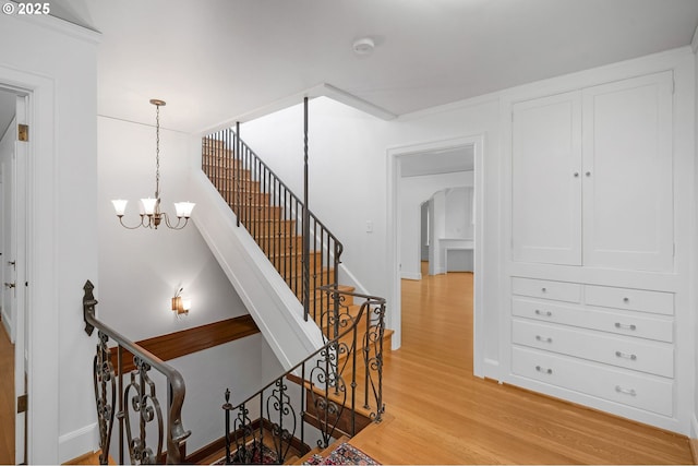 2668 NW Cornell Rd, Portland, OR 97210 - staircase featuring wood finished floors and a chandelier