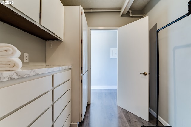 interior space with white cabinetry and light hardwood / wood-style flooring