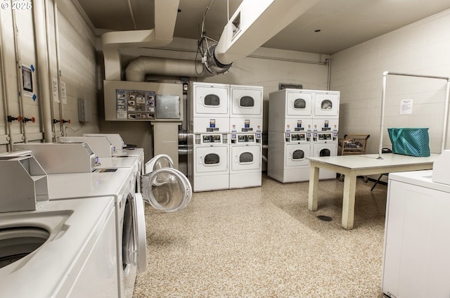 laundry area with independent washer and dryer and stacked washer and clothes dryer