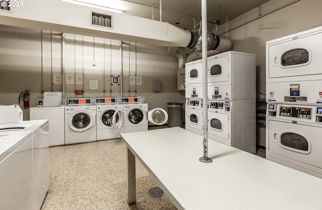 laundry area with stacked washer / dryer and independent washer and dryer