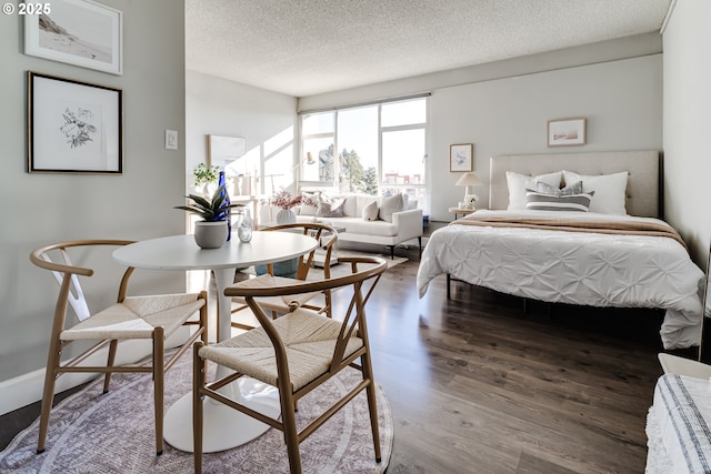 bedroom featuring hardwood / wood-style flooring and a textured ceiling