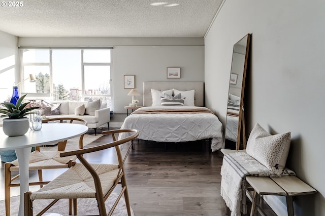 bedroom with hardwood / wood-style floors and a textured ceiling