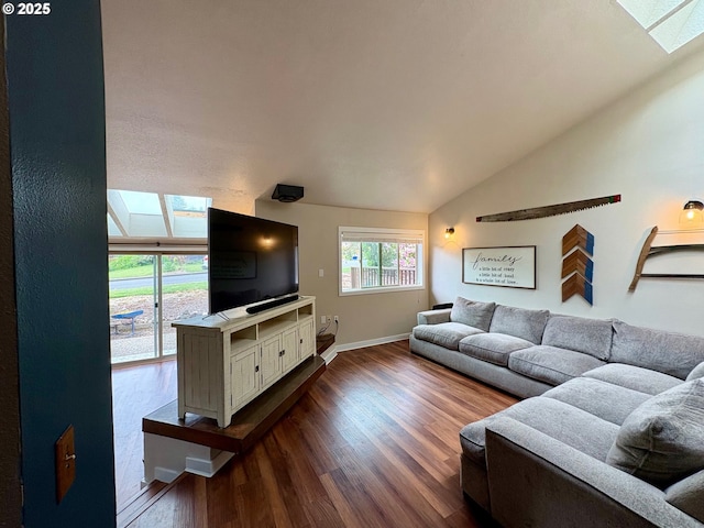 892 S 55th Pl, Springfield, OR 97478 - living area featuring a skylight, vaulted ceiling, dark wood-style floors, and baseboards