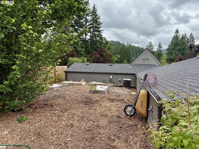 892 S 55th Pl, Springfield, OR 97478 - view of property exterior with central AC and a shingled roof