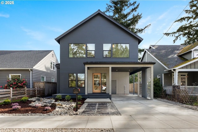 contemporary home with fence and driveway