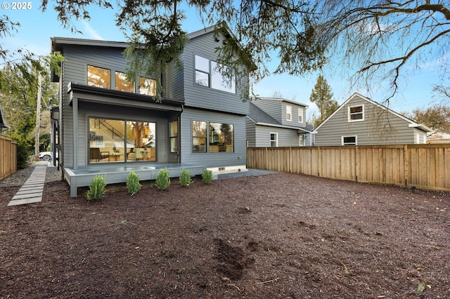 back of property featuring fence