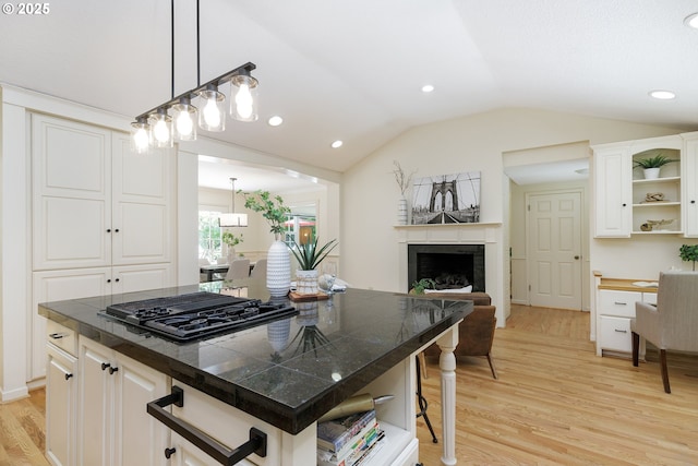17243 Fernwood Dr, Lake Oswego, OR 97034 - kitchen featuring open shelves, black gas cooktop, light wood-style floors, lofted ceiling, and a fireplace