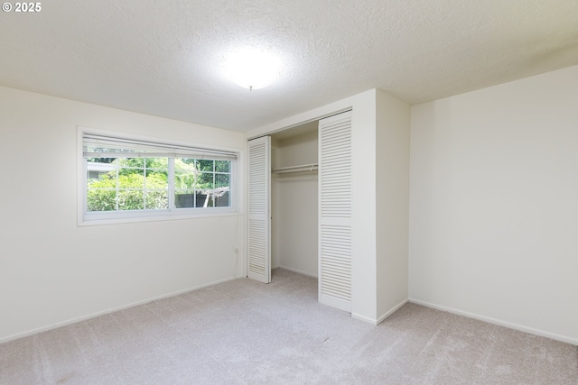 17243 Fernwood Dr, Lake Oswego, OR 97034 - unfurnished bedroom featuring light carpet, a closet, a textured ceiling, and baseboards