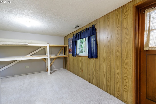 17243 Fernwood Dr, Lake Oswego, OR 97034 - unfurnished bedroom featuring carpet, a textured ceiling, and wooden walls