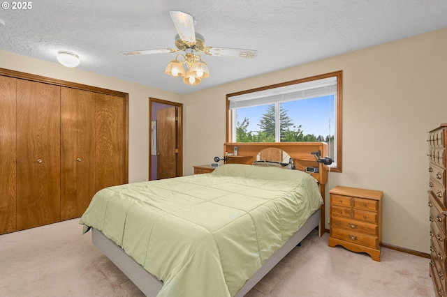 1415 SE 52nd Ave, Hillsboro, OR 97123 - bedroom with light colored carpet, a closet, a textured ceiling, baseboards, and ceiling fan
