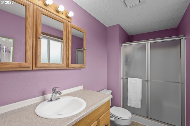 1415 SE 52nd Ave, Hillsboro, OR 97123 - full bath featuring toilet, a shower stall, a textured ceiling, and vanity