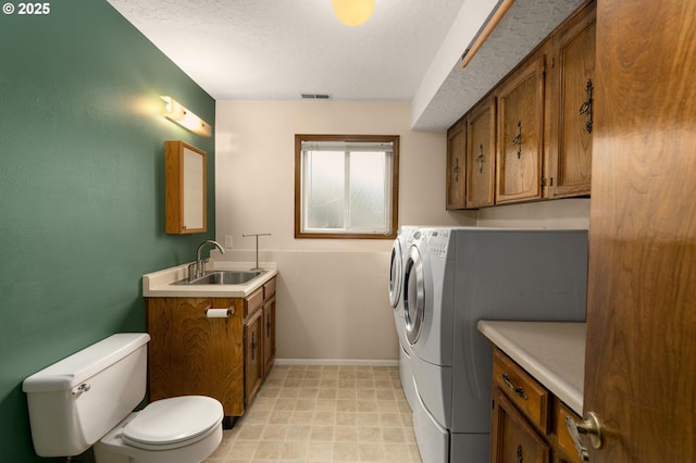 1415 SE 52nd Ave, Hillsboro, OR 97123 - laundry area featuring independent washer and dryer, baseboards, a textured ceiling, and light flooring