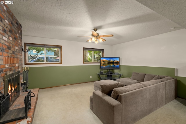1415 SE 52nd Ave, Hillsboro, OR 97123 - carpeted living room with a textured ceiling, ceiling fan, a brick fireplace, and baseboards