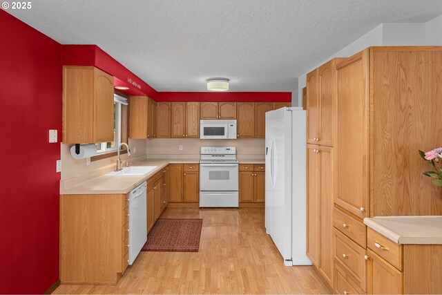 1415 SE 52nd Ave, Hillsboro, OR 97123 - kitchen with white appliances, a sink, light wood-style floors, light countertops, and a textured ceiling
