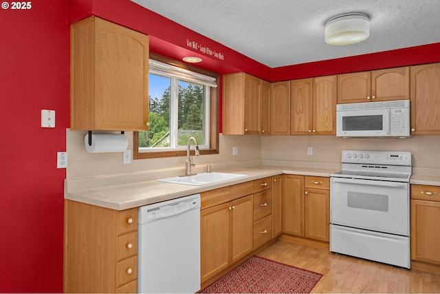 1415 SE 52nd Ave, Hillsboro, OR 97123 - kitchen with white appliances, a sink, light wood-style floors, light countertops, and a textured ceiling
