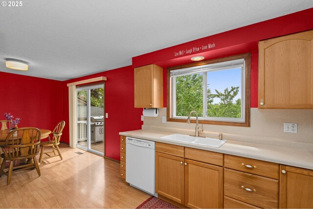 1415 SE 52nd Ave, Hillsboro, OR 97123 - kitchen with white dishwasher, a sink, light countertops, light wood-type flooring, and a textured ceiling