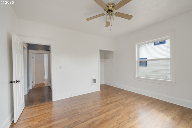 1006 Stillwell Ave, Tillamook, OR 97141 - unfurnished bedroom with light wood-style floors, baseboards, a closet, and a ceiling fan