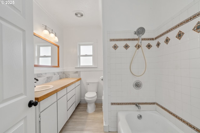 1006 Stillwell Ave, Tillamook, OR 97141 - bathroom with vanity, bathtub / shower combination, toilet, wood finished floors, and ornamental molding