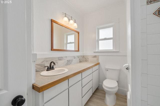 1006 Stillwell Ave, Tillamook, OR 97141 - bathroom featuring vanity, toilet, wood finished floors, and crown molding