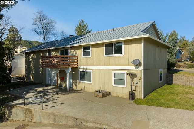 1521 Ranch Rd, Reedsport, OR 97467 - rear view of property featuring a patio area, a wooden deck, metal roof, and a standing seam roof
