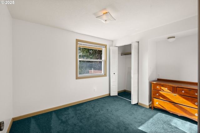 1521 Ranch Rd, Reedsport, OR 97467 - unfurnished bedroom with dark carpet, a closet, and baseboards