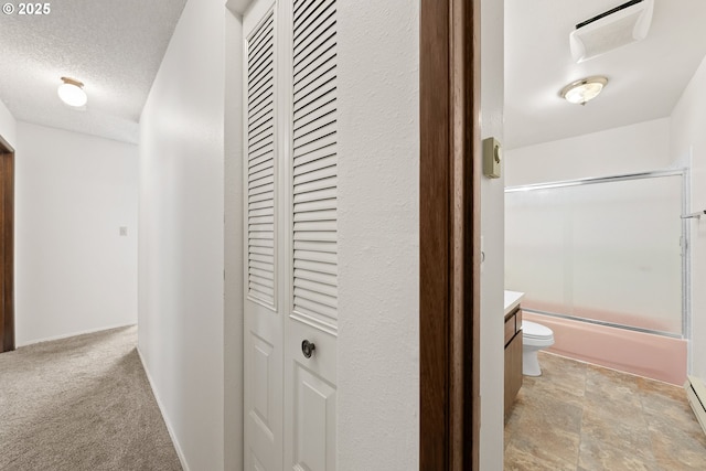 1521 Ranch Rd, Reedsport, OR 97467 - hallway featuring a textured ceiling and baseboard heating